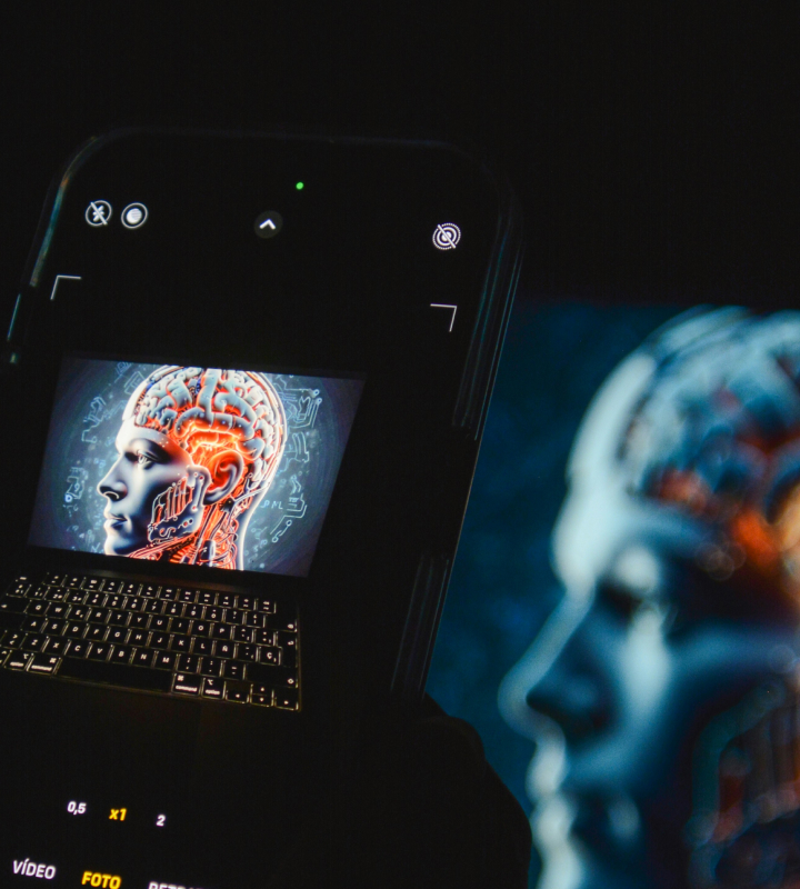 En mobiltelefon tager et billede af en computerskærm, hvor der vises et billede af kunstig intelligens.